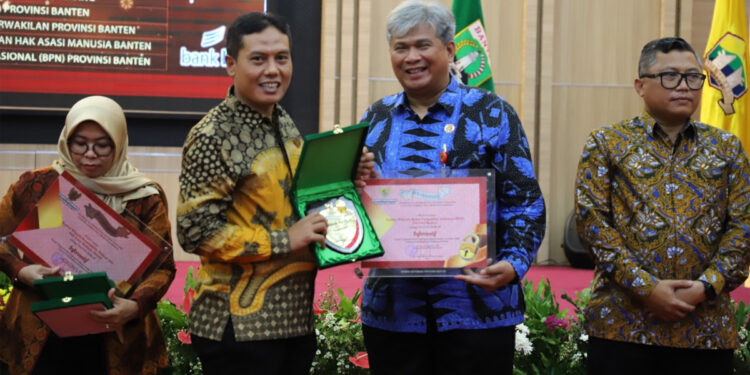 Kepala Kanwil BPN Banten Rudi Rubijaya menerima piagam penghargaan keterbukaan informasi publik dari Komisi Informasi Banten (Yasril/ INDOPOS.CO.ID)
